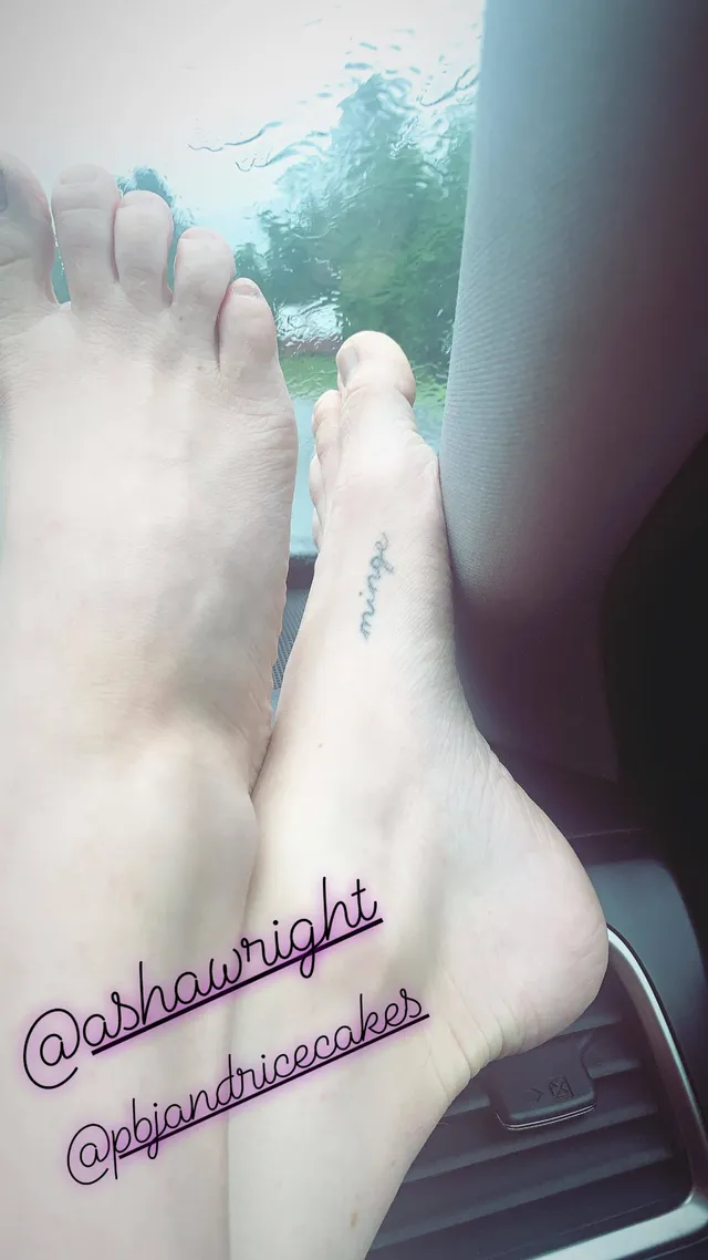 Amanda Seyfried with bare feet extended beside another person indoors.