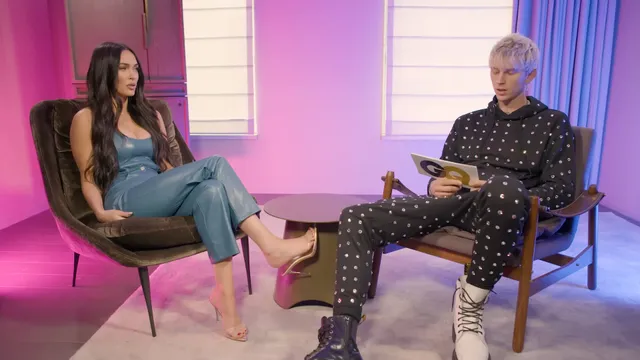 Megan Fox sitting in a television studio chair.
