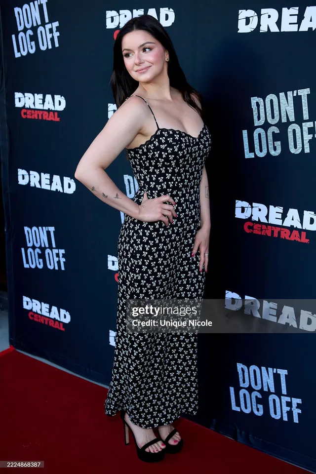 Ariel Winter posing at a premiere in a patterned dress.