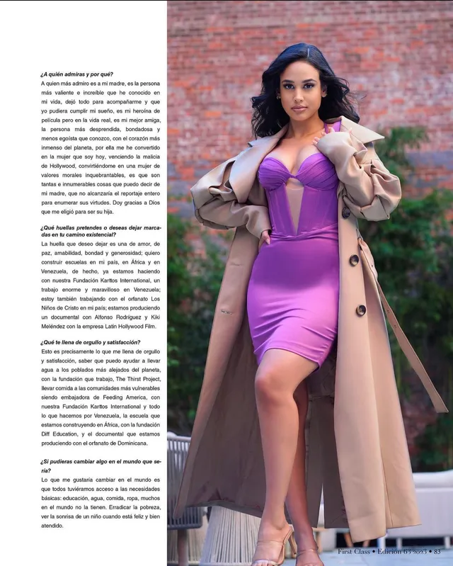 Emily Tosta wearing a purple dress and heels in a magazine photograph.
