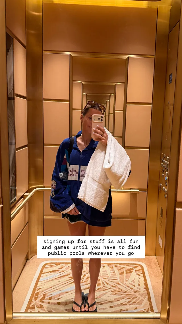 Claire Holt taking an elevator mirror portrait in flip-flops.