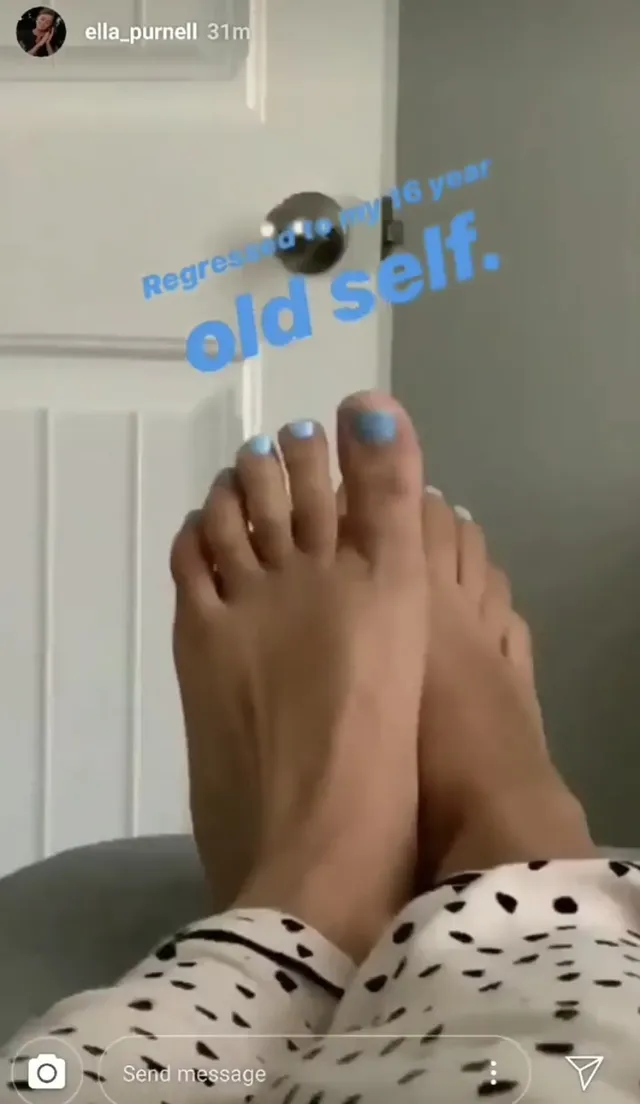 Ella Purnell showing pale blue nail polish while relaxing.