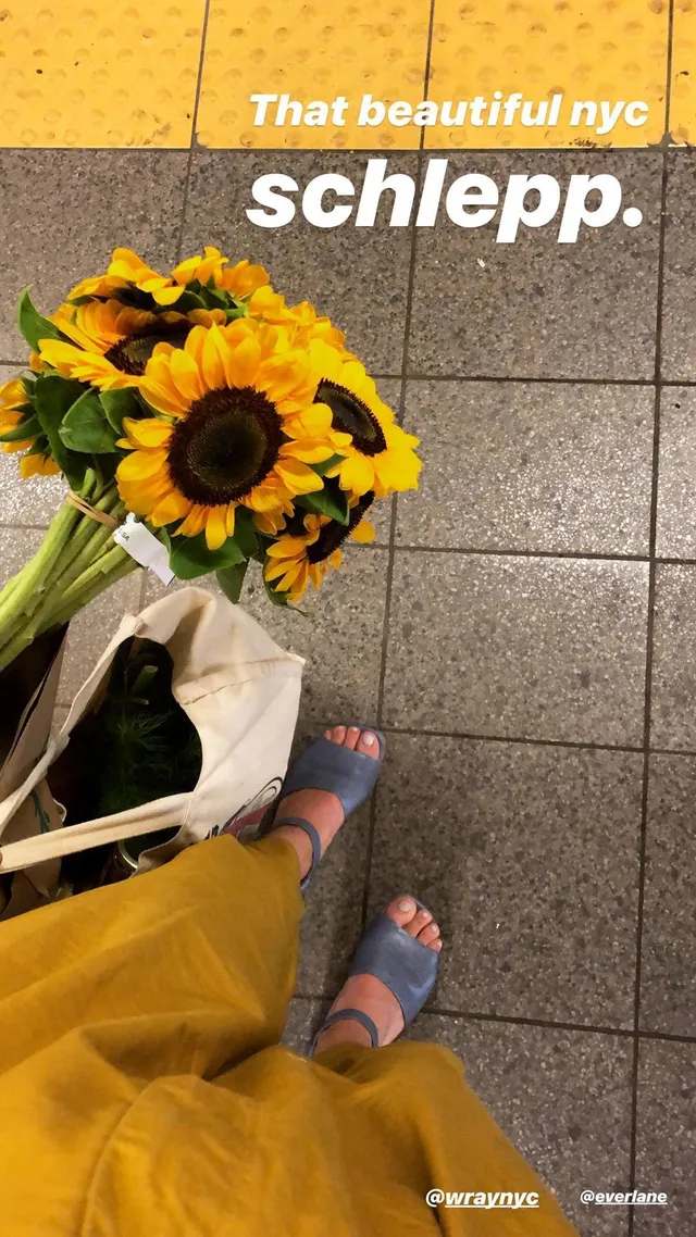 Willa Fitzgerald wearing pale blue flat sandals outdoors.