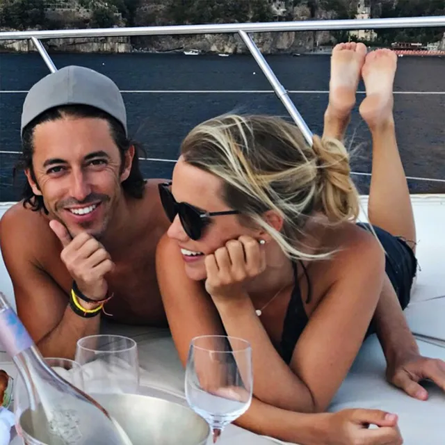 Claire Holt relaxing with a companion on a boat.