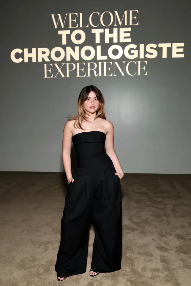 Nicole Wallace wearing a black strapless jumpsuit at an event.
