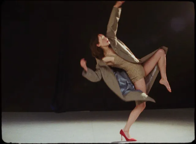 Havana Rose Liu dancing with one red heel and one bare foot.