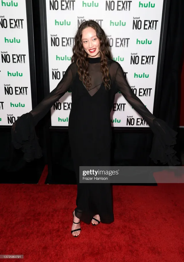 Havana Rose Liu wearing a black gown and heels at a premiere.
