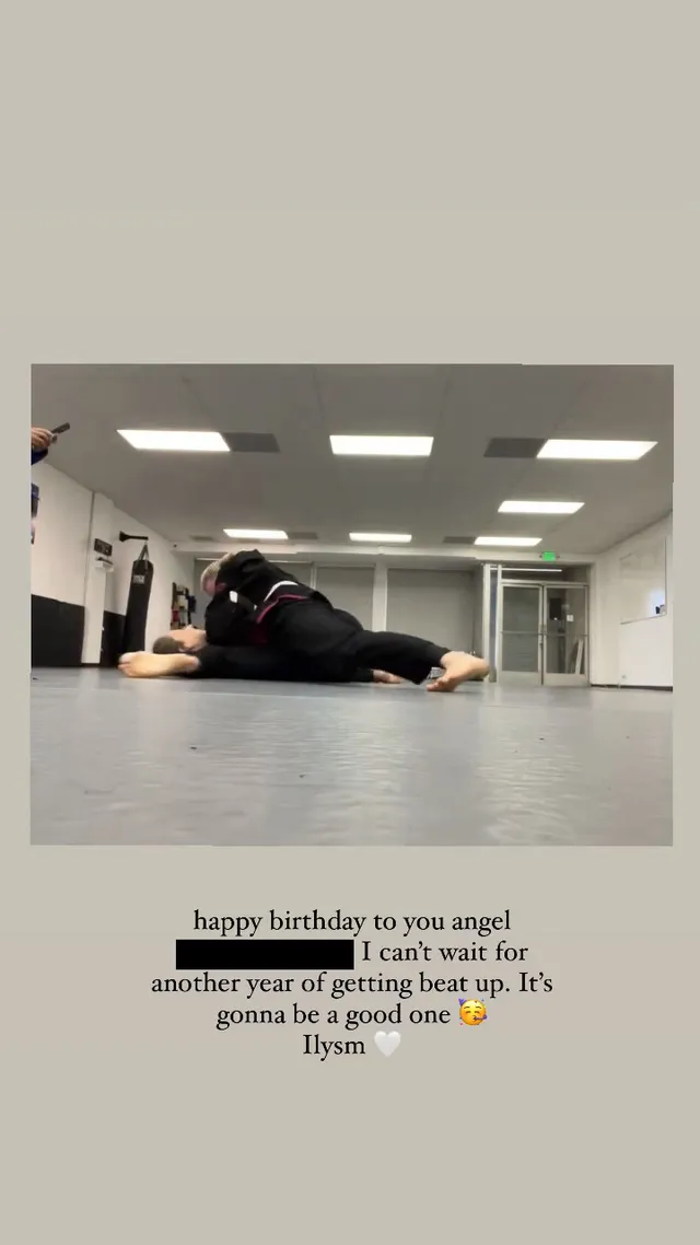 Chloë Grace Moretz lying barefoot on a gym floor during training.