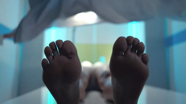 Gemma Chan resting with her feet toward the camera in a screen scene.