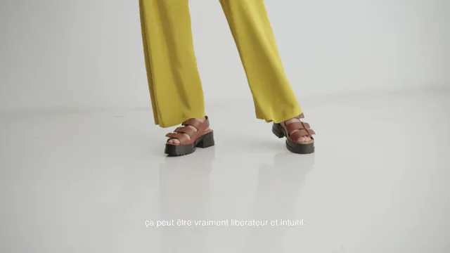 Havana Rose Liu showing brown sandals beneath yellow trousers.