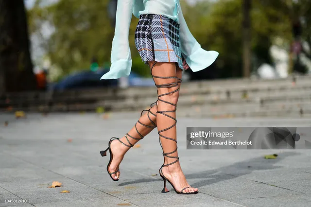 Bruna Marquezine shown wearing black lace-up heels outdoors.