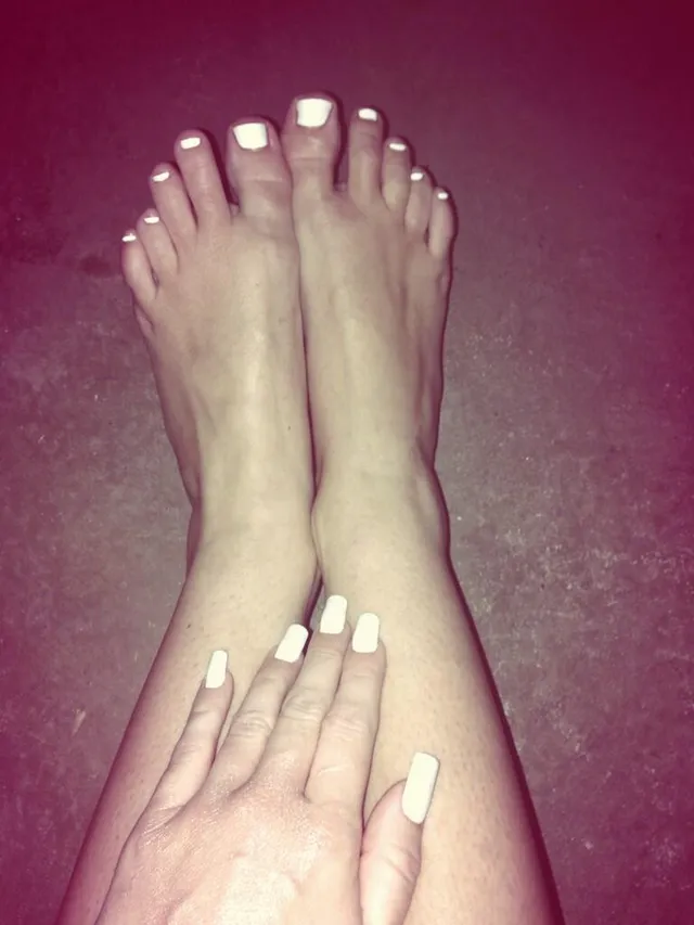 Miley Cyrus showing painted bare toes in a close-up.