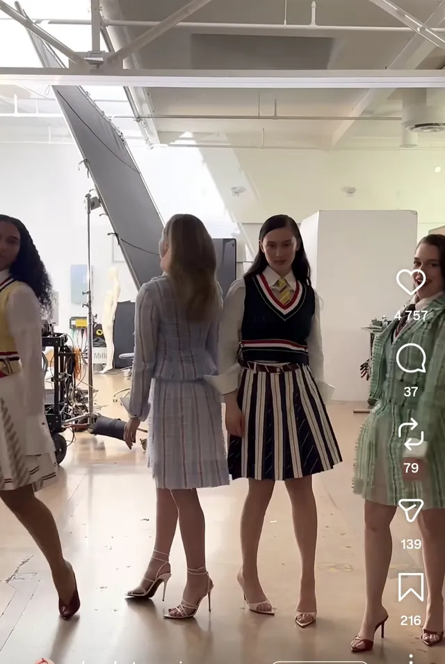 Victoria Pedretti posing with companions during a fashion shoot.