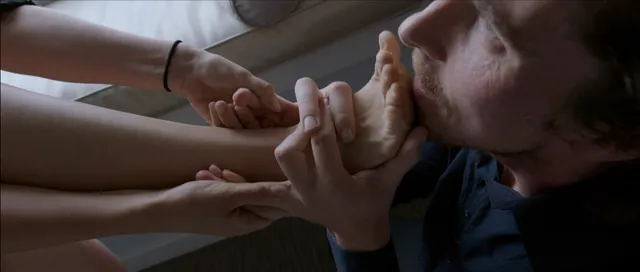 Natalie Portman appearing in a scene with a bare foot held beside her.