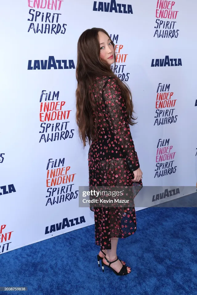 Havana Rose Liu wearing a floral dress and black heels at an event.