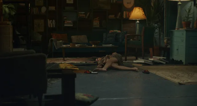 Zoë Kravitz lying on a floor in a dimly lit screen scene.