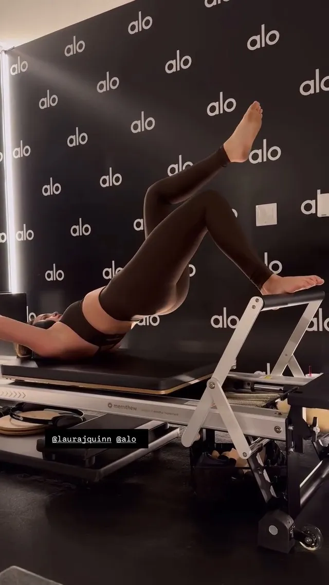 Bailee Madison exercising barefoot on a Pilates machine.