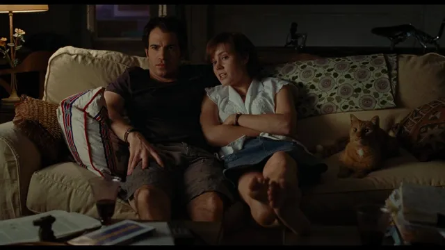 Amy Adams sitting beside a companion on a sofa.