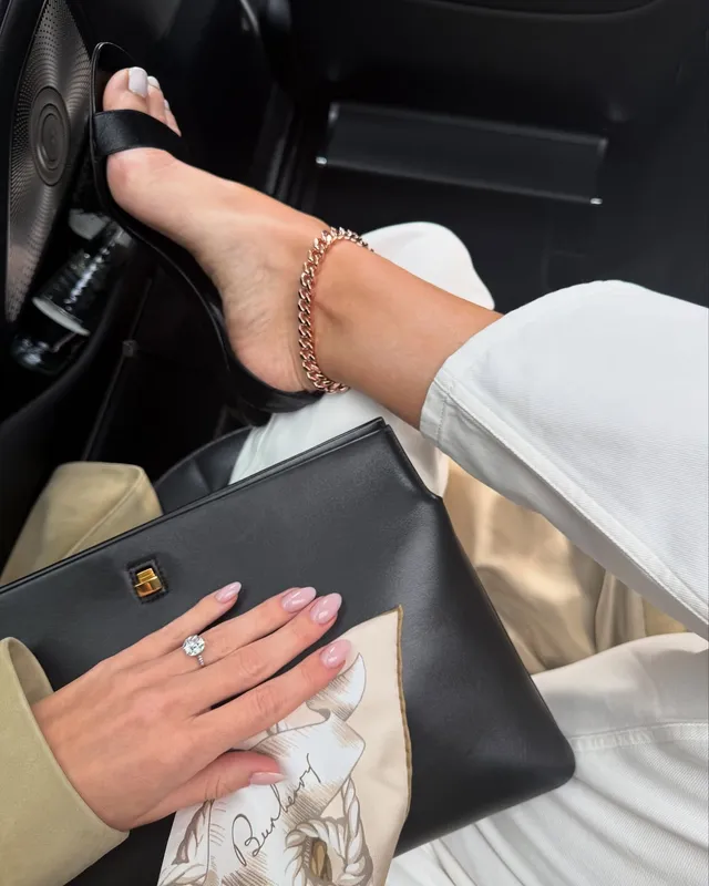 Rosie Huntington-Whiteley a black open-toe heel in a car.