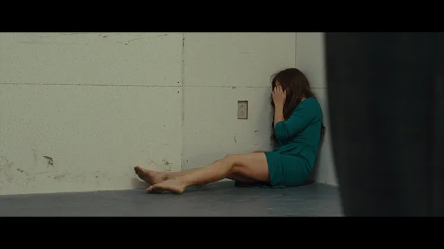 Amy Adams sitting on a floor during a screen scene.