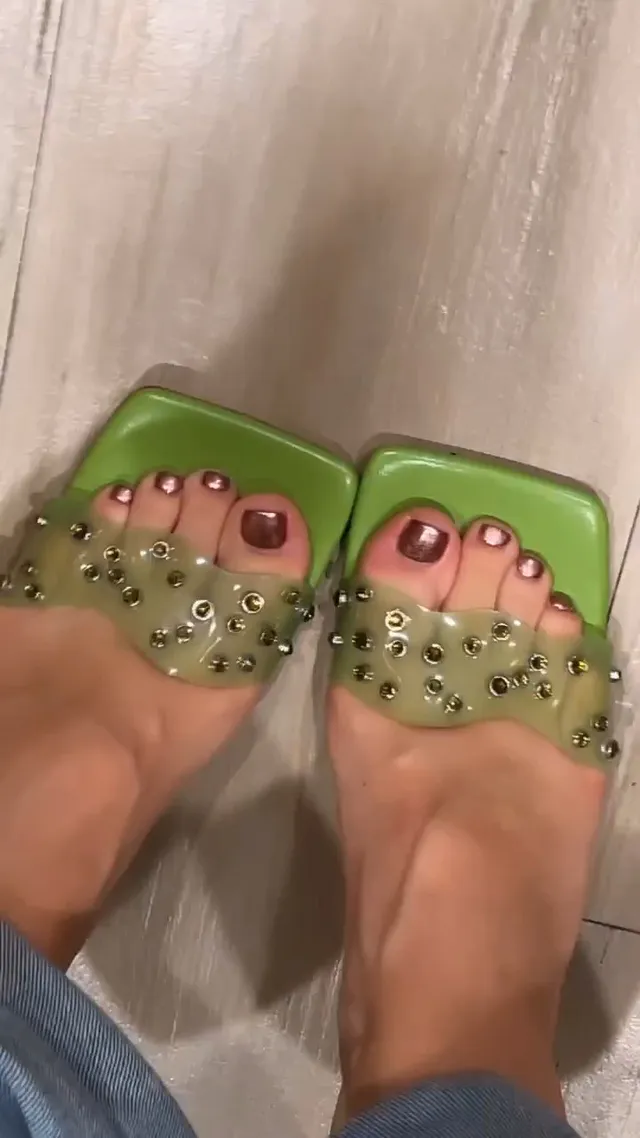 Isabela Merced wearing green embellished open-toe heels.
