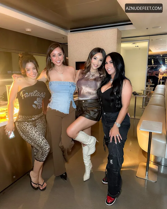 Cierra Ramirez posing with friends in casual outfits indoors.
