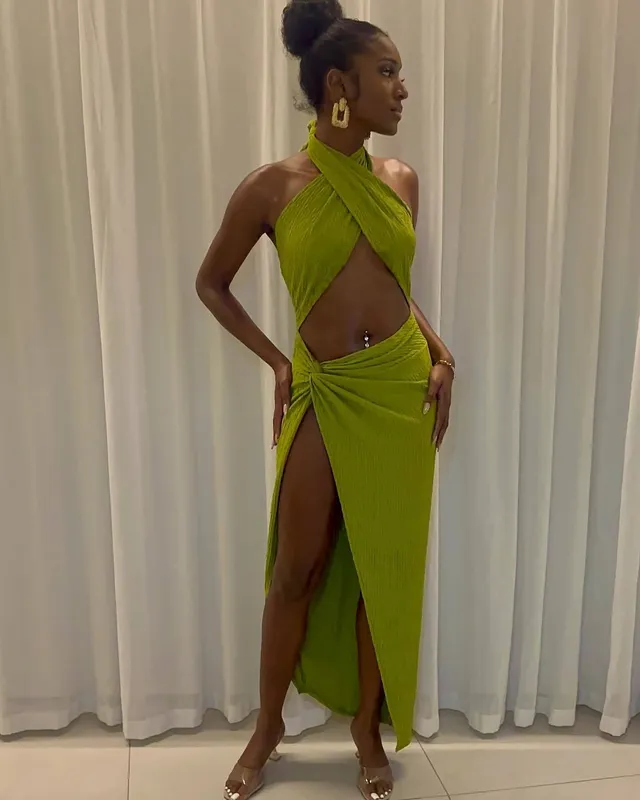 Carlacia Grant posing in a lime green gown and pale heels.