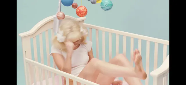 Miley Cyrus posing barefoot in a pastel set.