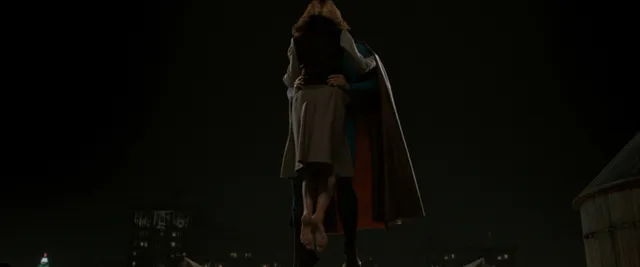 Kate Bosworth standing beside a man in a dimly lit scene.