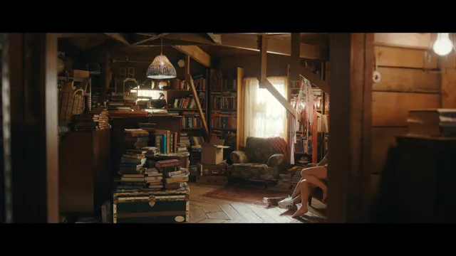 Emily Alyn Lind appearing in a wooden room with bare feet visible in a scene.