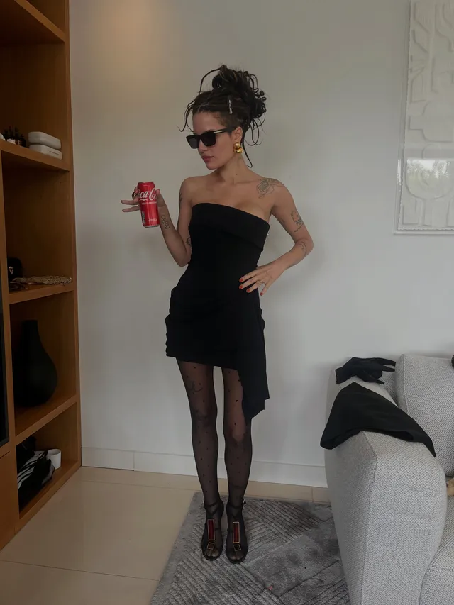Halsey a black outfit with sheer tights in a mirror portrait.