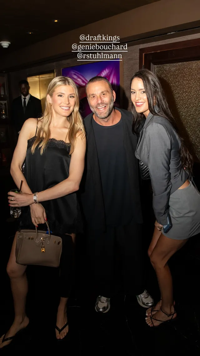 Eugenie Bouchard posing beside companions in black heeled sandals and a dark dress.