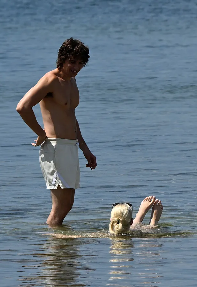 Anya Taylor-Joy swimming barefoot beside another person.