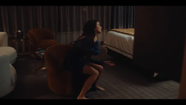 Alycia Debnam-Carey sitting in a chair during a screen scene.