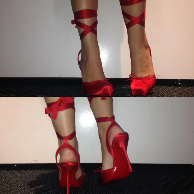 Ariana Greenblatt wearing red strappy heels in a close-up photograph.