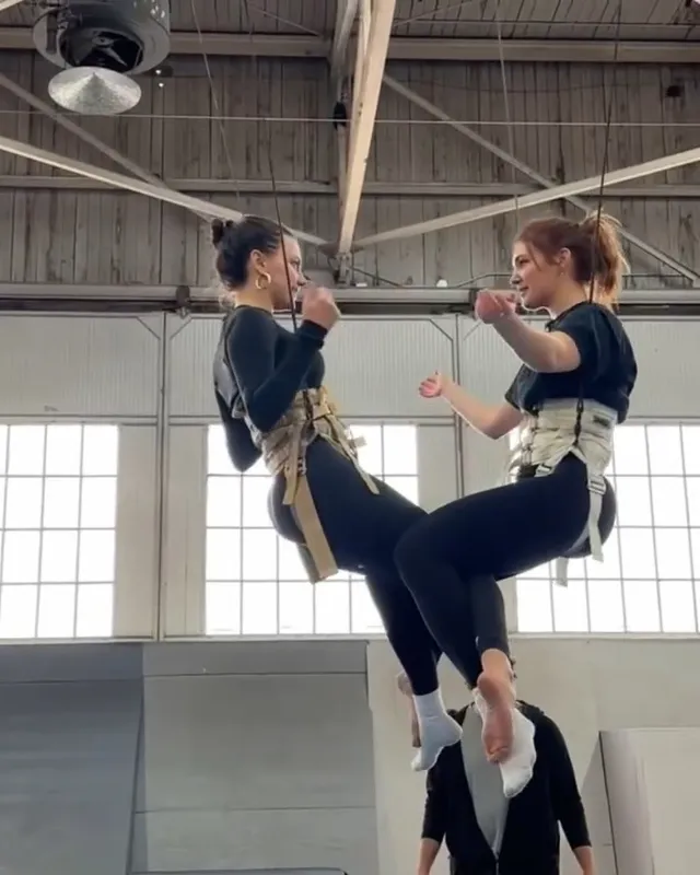Dafne Keen practicing an aerial exercise in pale socks.