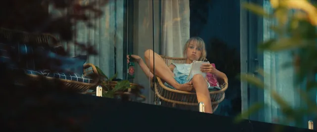 Teresa Palmer resting in a chair during a screen scene.
