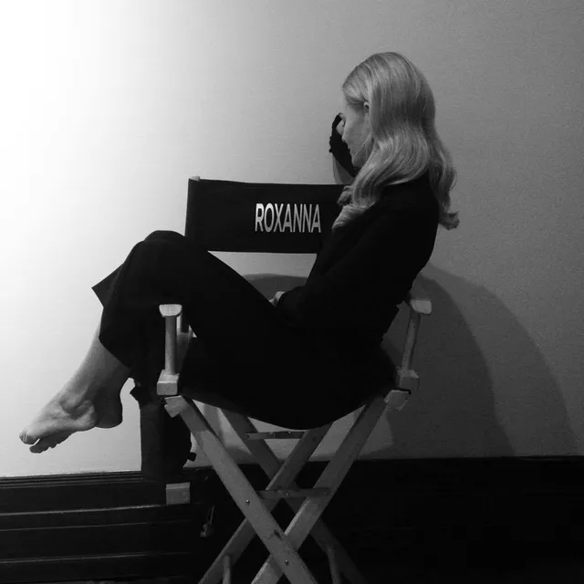 Kate Bosworth sitting in a tall chair in a monochrome portrait.