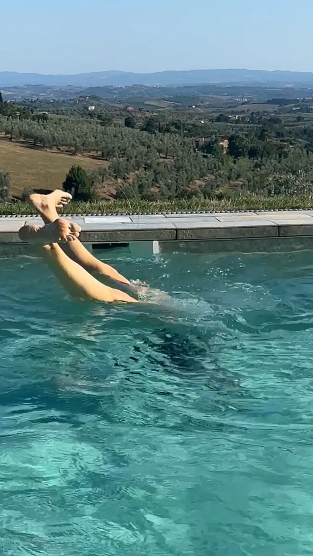 Jennifer Garner swimming in a pool overlooking the countryside.