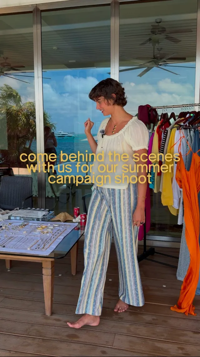 Taylor Hill standing barefoot in a clothing studio in striped trousers.