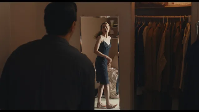 Sarah Pidgeon appearing barefoot beside a man in a bedroom scene.