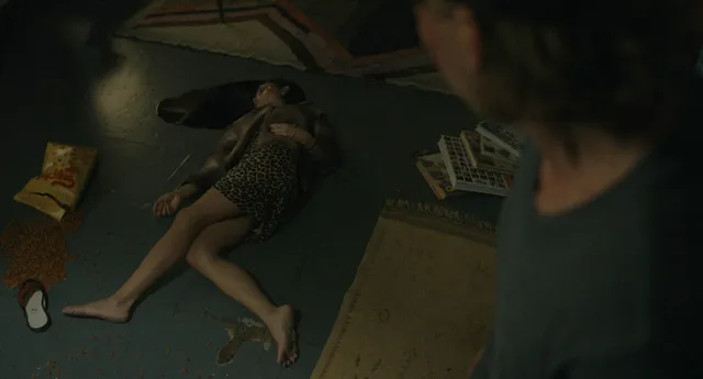 Zoë Kravitz lying on a floor in a screen scene.