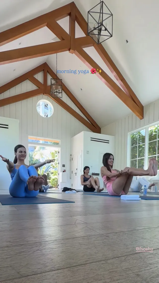 Victoria Justice exercising on a mat in a sunlit room.