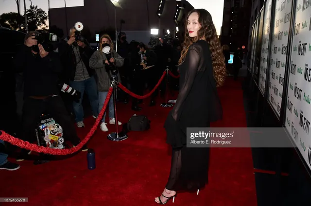 Havana Rose Liu posing on a red carpet in black heels.