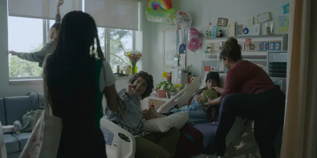 Odessa A'zion sitting in heels during an interior scene.