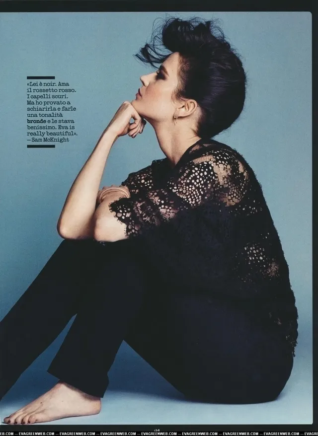 Eva Green sitting barefoot in a black outfit for a magazine portrait.