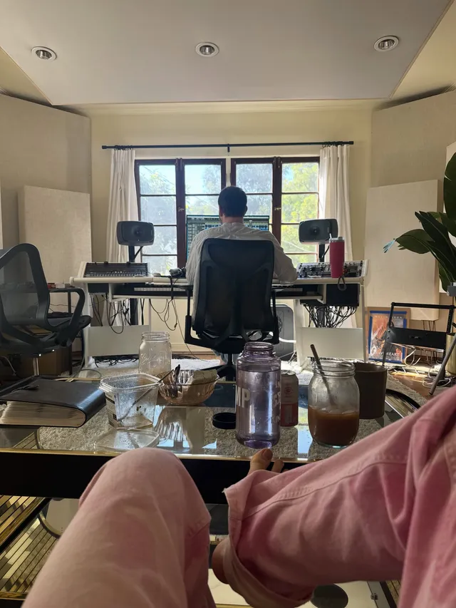 Tove Lo resting a bare foot toward a dressing-room mirror.