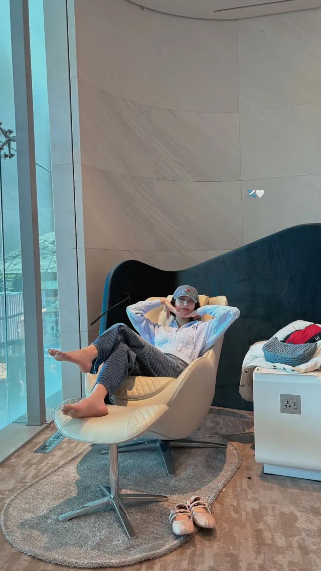 Jang Wonyoung reclining in a chair with bare soles visible.