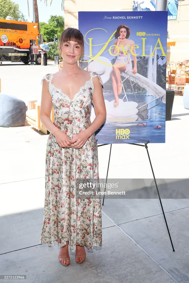 Leighton Meester posing at a film event in a floral dress.