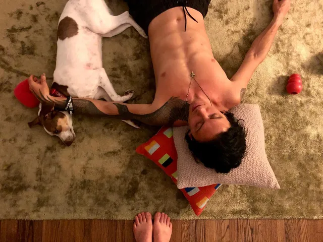Willa Fitzgerald showing bare toes beside a dog.
